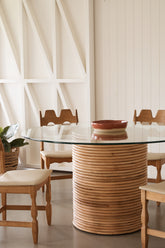 Side profile showcasing the oak and rattan base of Palma Dining Table
